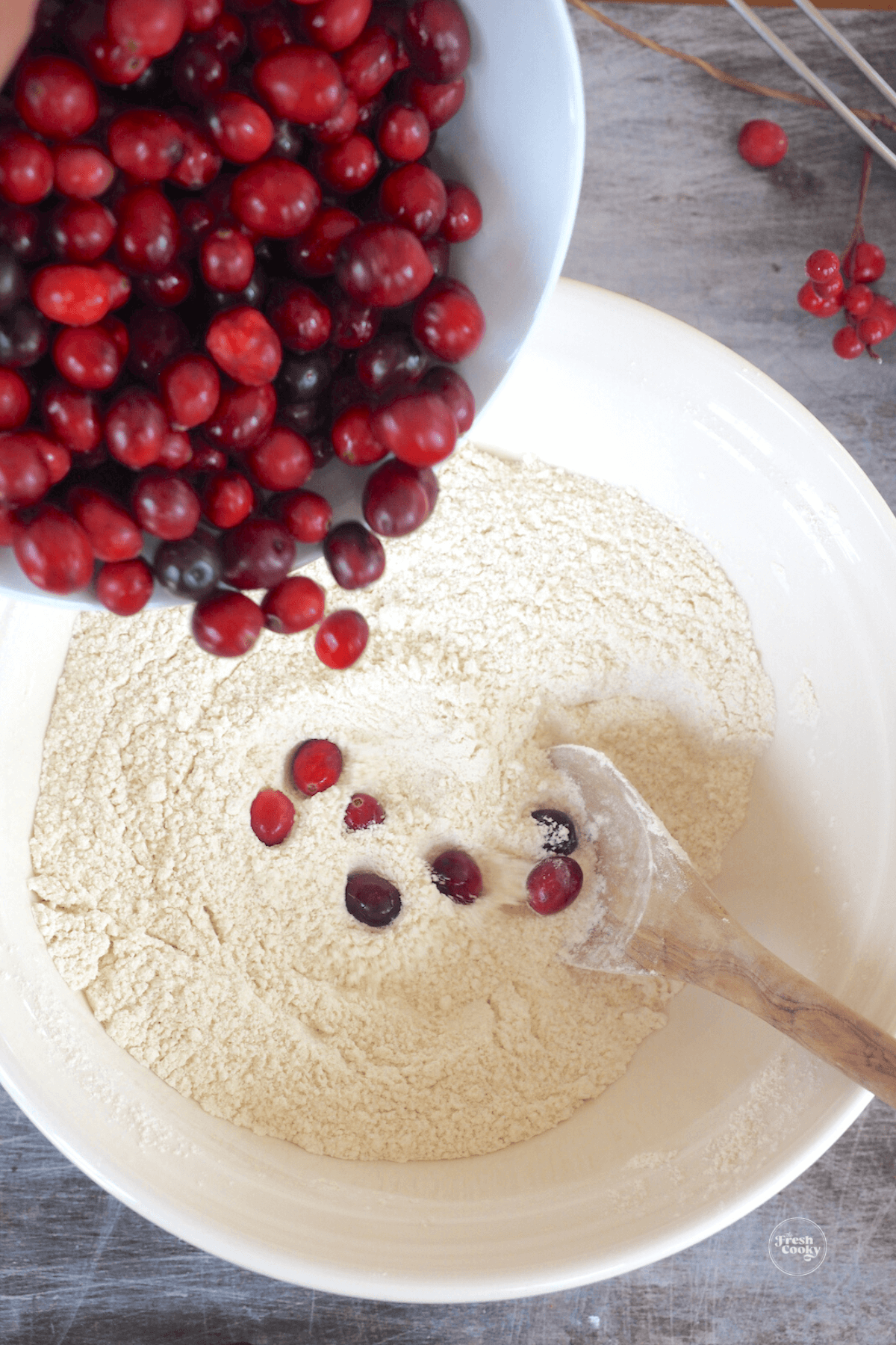Stirring cranberries into flour mixture. 