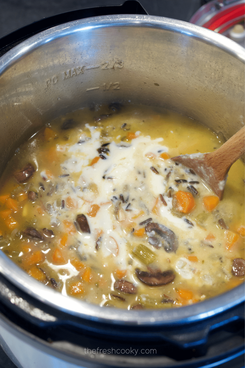 Stirring in roux to thicken the chicken and wild rice soup. 
