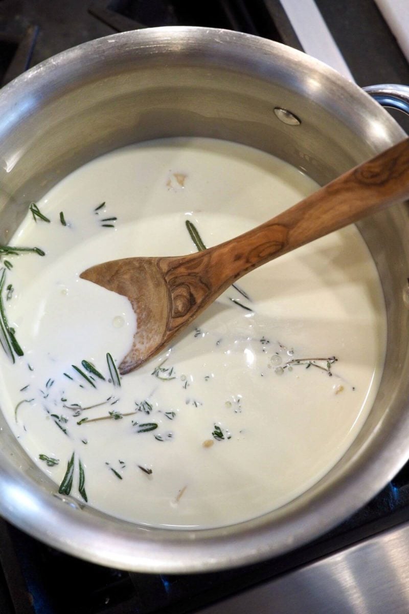 Simmering herbed cream mixture.