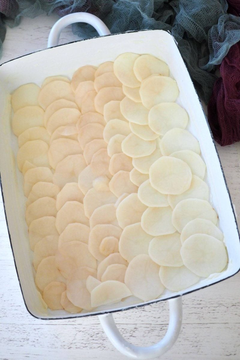 Layer of sliced potatoes on bottom of prepared casserole.