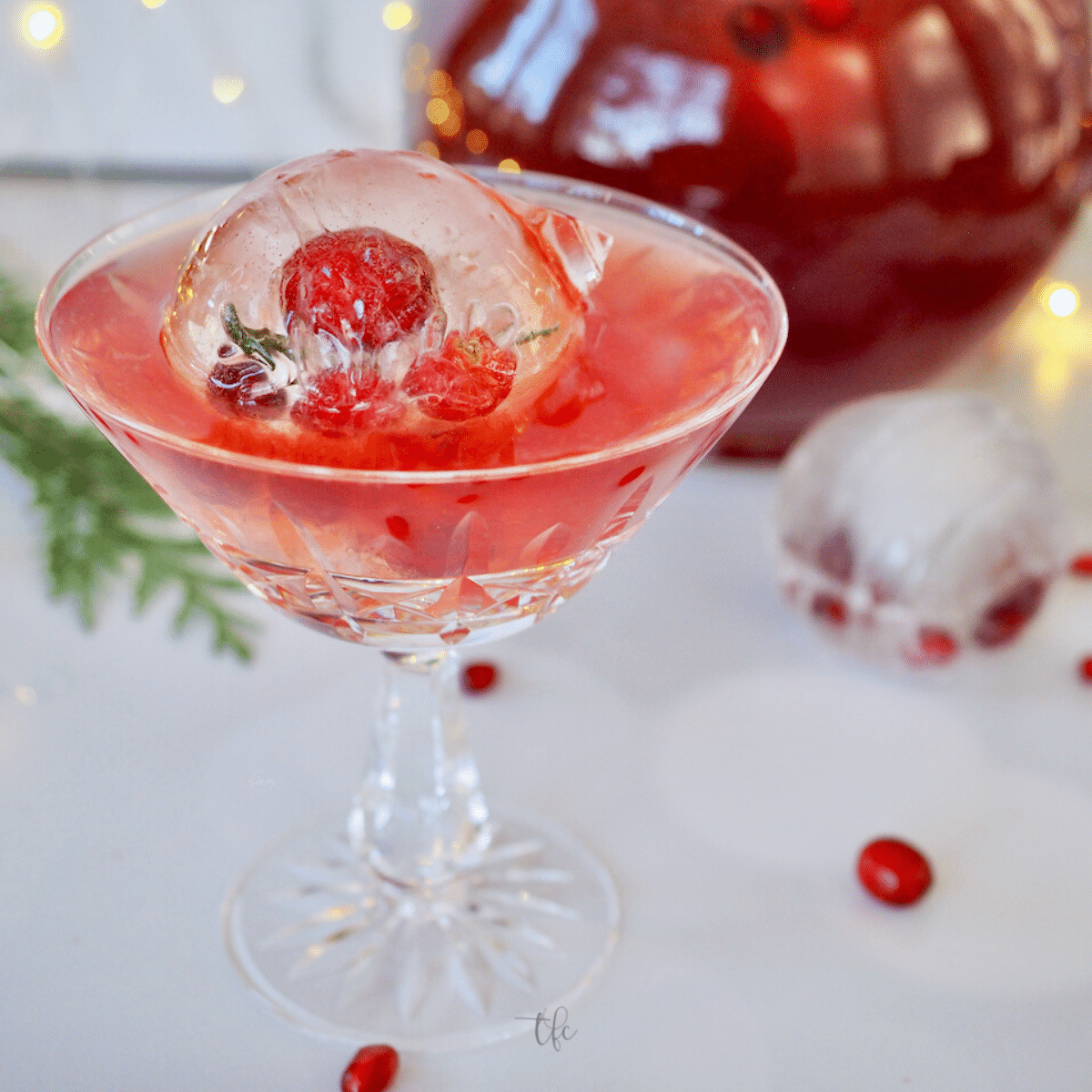 Pomegranate Punch in pretty glass with ornament ice ball.