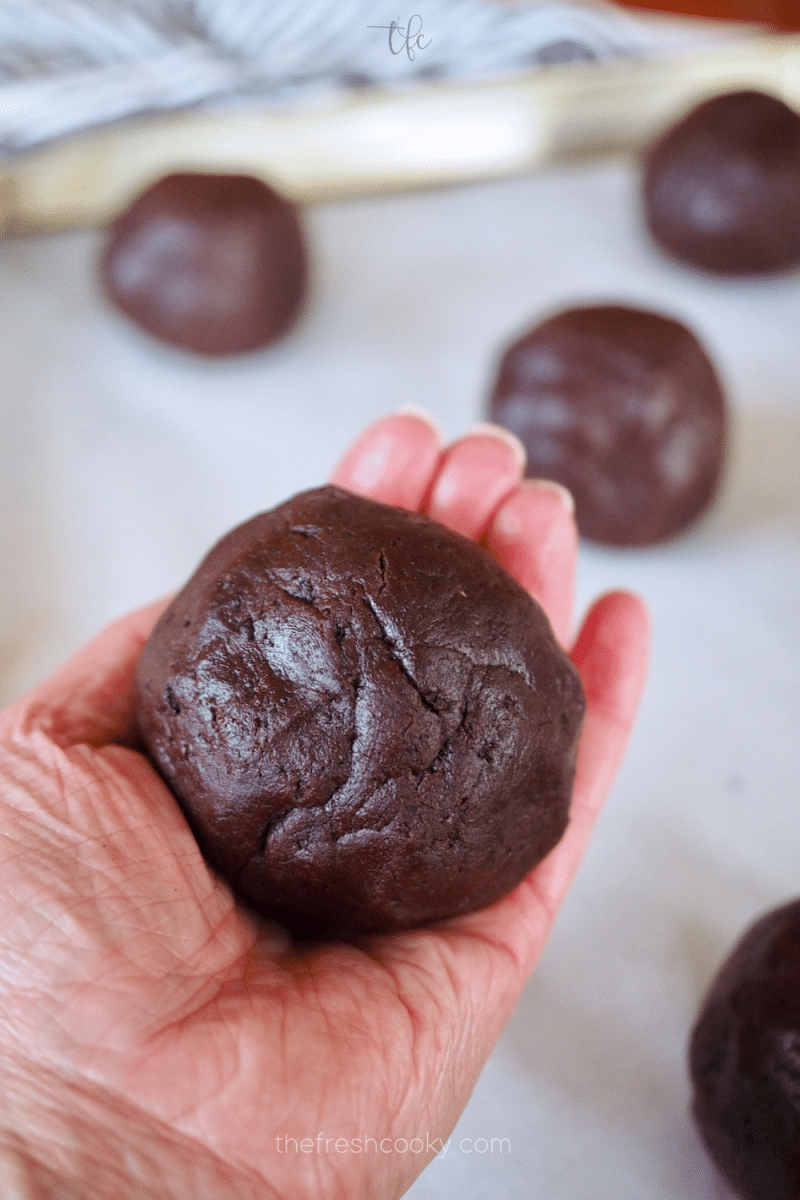 Giant Oreo Crumbl Cookie dough ball in hand. 