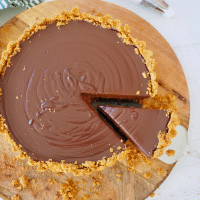 No bake chocolate pie with graham cracker crust with wedge removed on pie server.