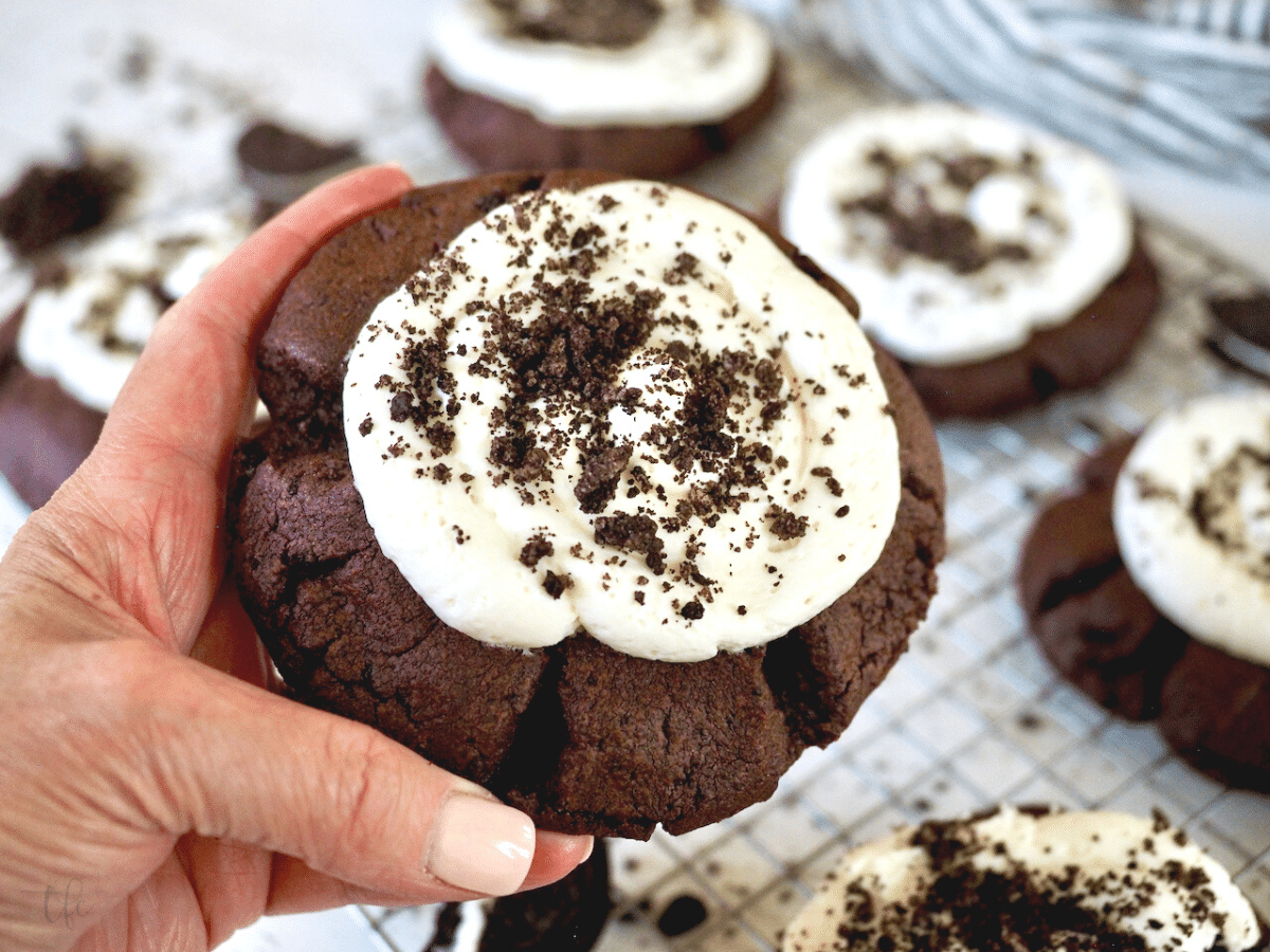 Hand holding giant Copycat Oreo Crumbl Cookie.