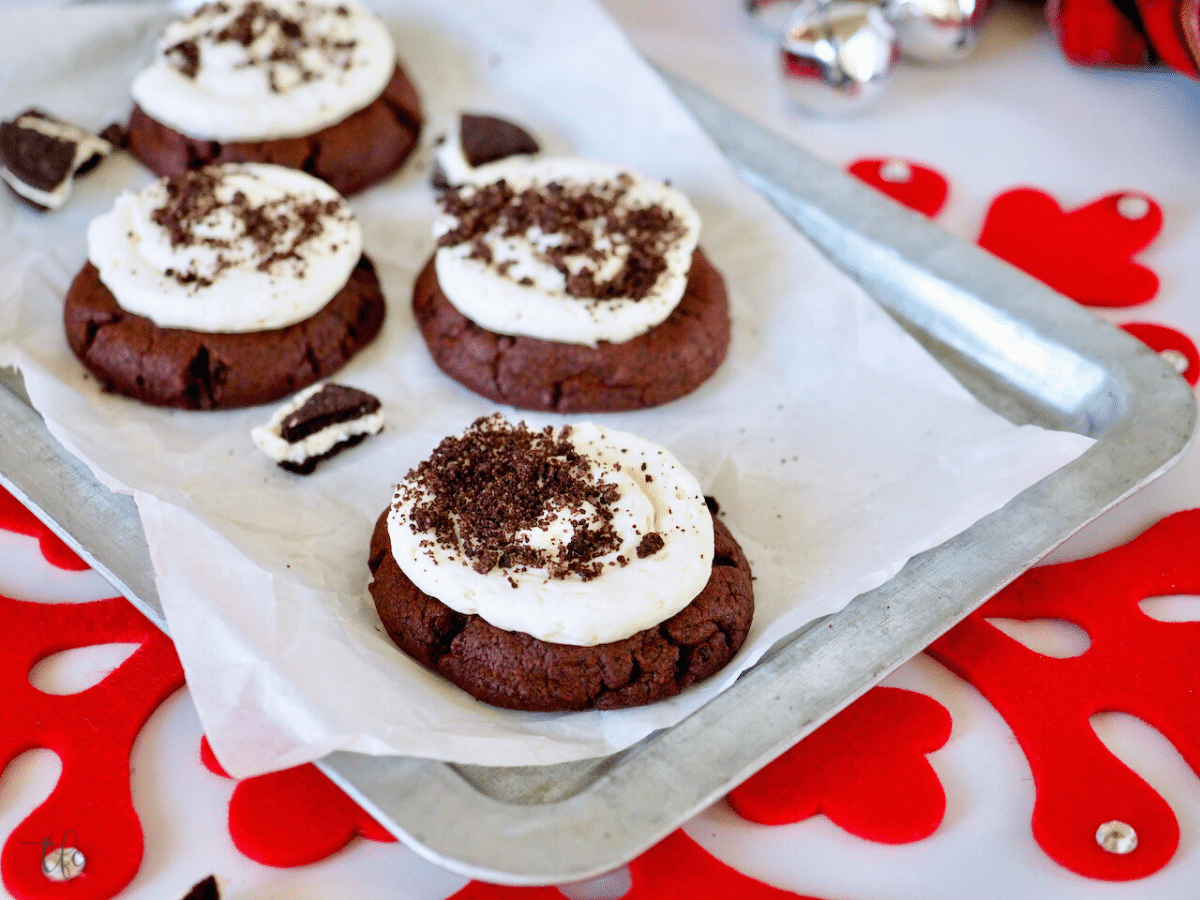 Oreo crumbl cookies on tray with broken Oreo Cookies around.