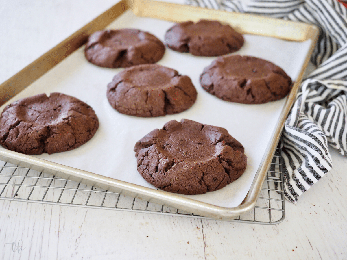 Crumbl Oreo Cookies fresh from the oven on wire rack.