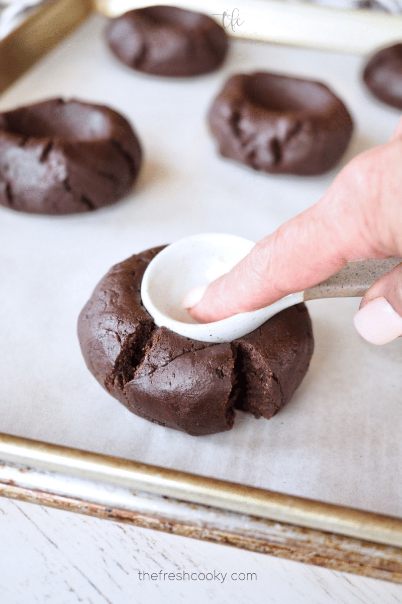 Using measuring spoon to press indent in Oreo Chocolate Cookies.