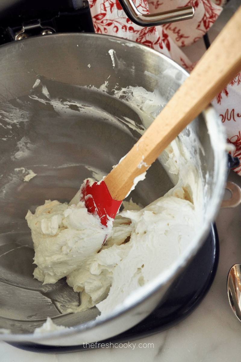 Whipped goat cheese mixture in mixing bowl. 