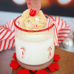 White Chocolate Peppermint Cookies being dunked into a glass of milk.