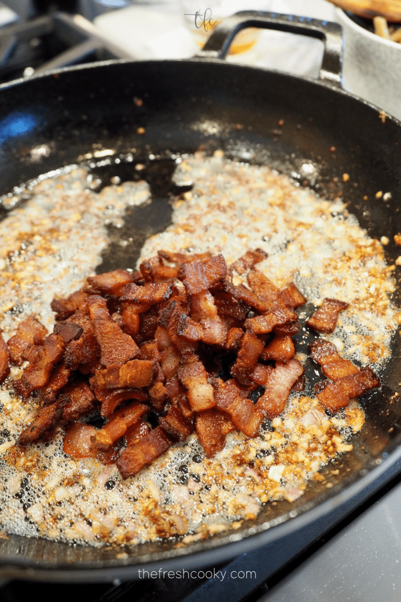 Crisp bacon added to sautéd shallots and garlic mixture for green bean casserole with bacon.  