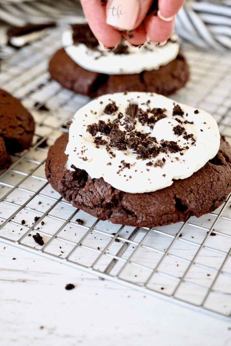 Adding a few Oreo crumbs to Oreo Crumbl Cookie. 