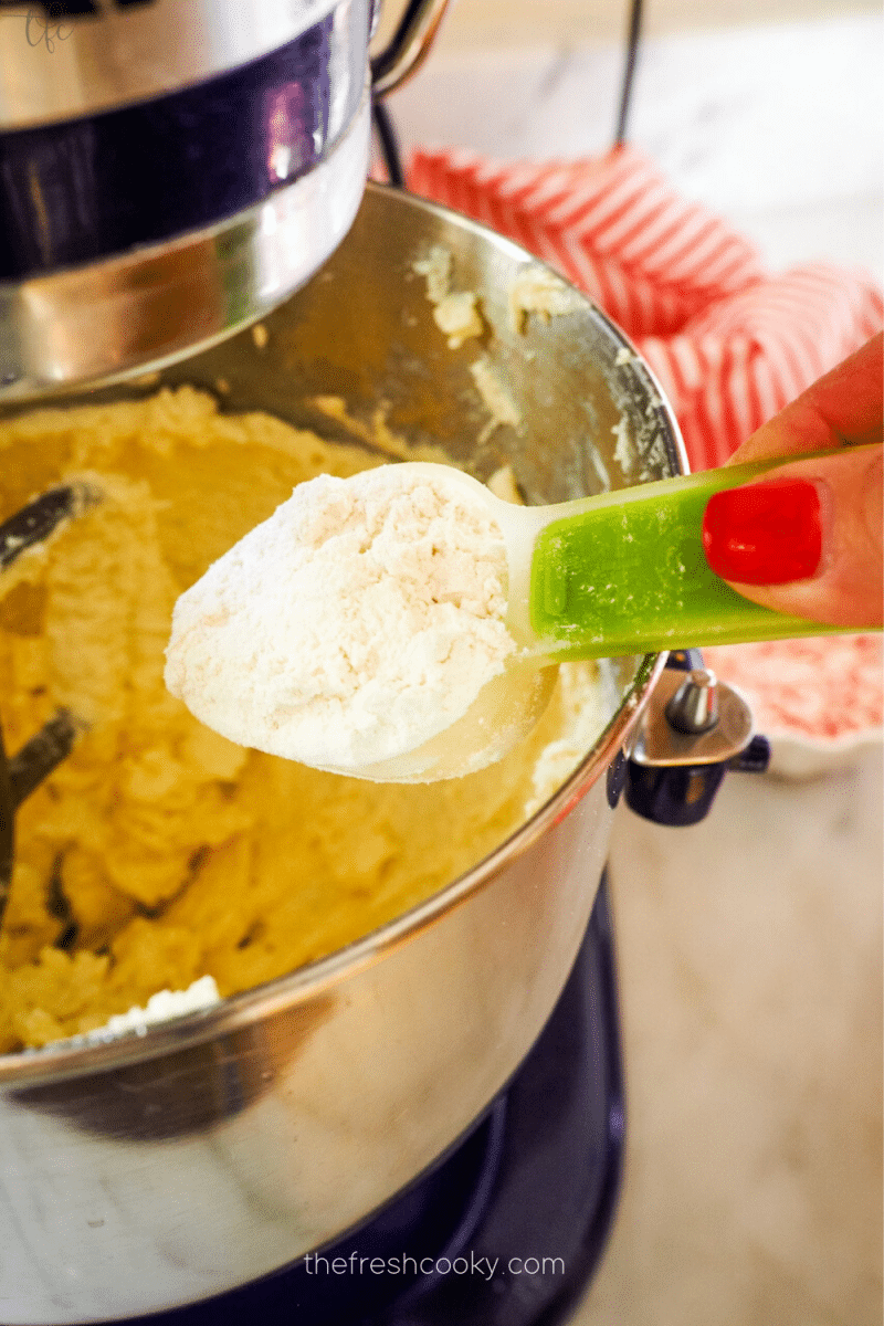 Adding flour white chocolate peppermint cookies. 