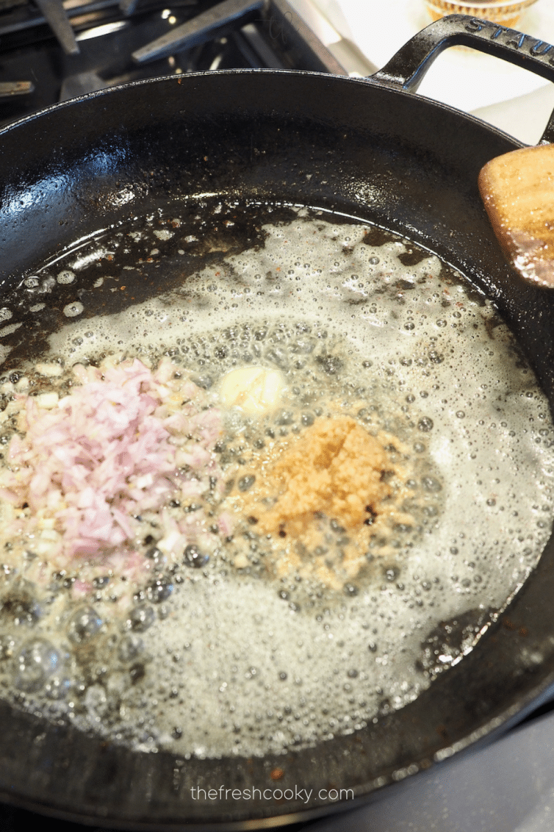 Sautéing shallots and garlic in bacon grease and a  little butter for canned green beans recipe.
