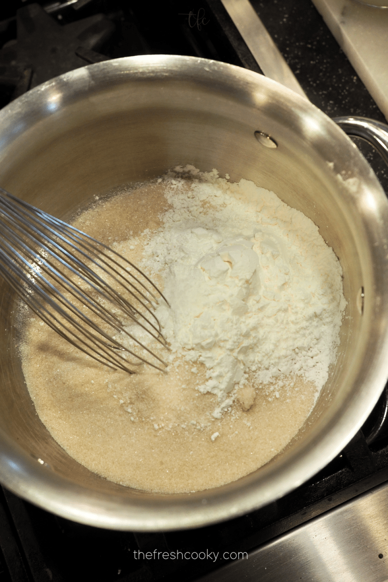 Whisking sugar and cornstarch together for chocolate pudding pie. 