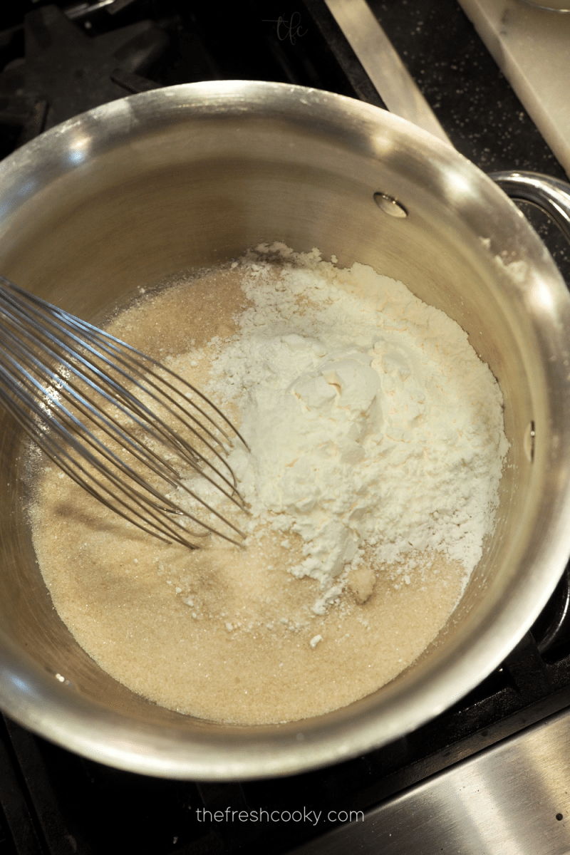 Whisking sugar and cornstarch together for chocolate pudding pie.