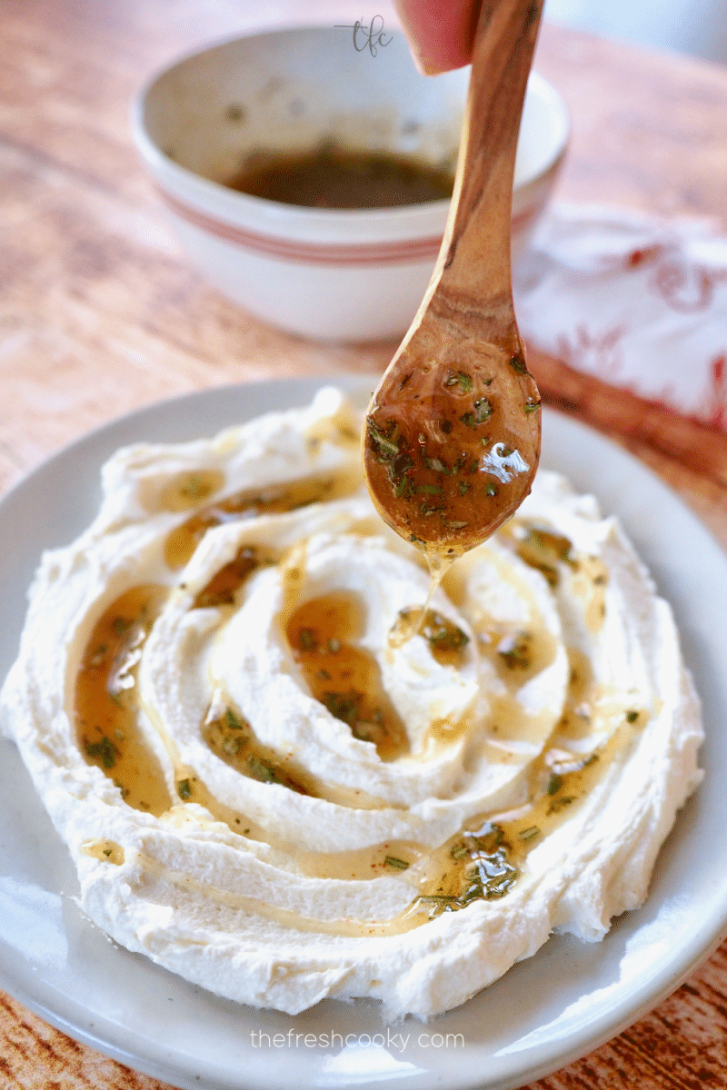 Drizzling honey over whipped goat cheese. 
