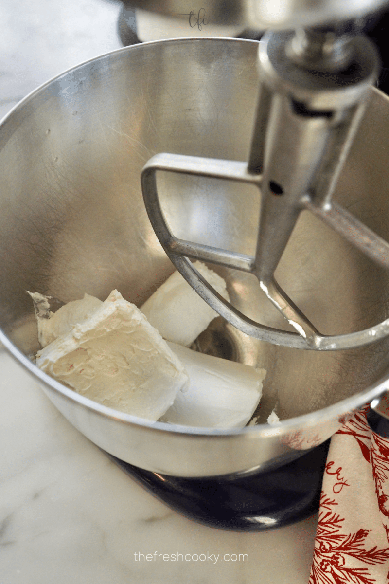 In bowl of stand mixer goat cheese and cream cheese. 