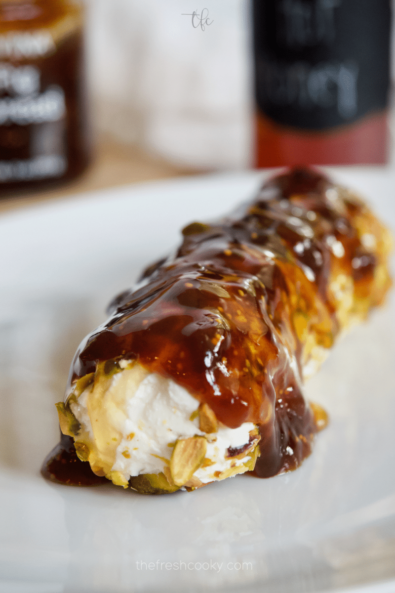 Goat cheese log, rolled in pistachios, drizzled with fig jam and hot honey.