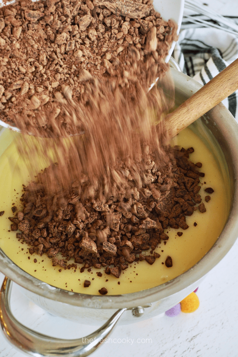 Pour chopped chocolate into hot pudding mixture.