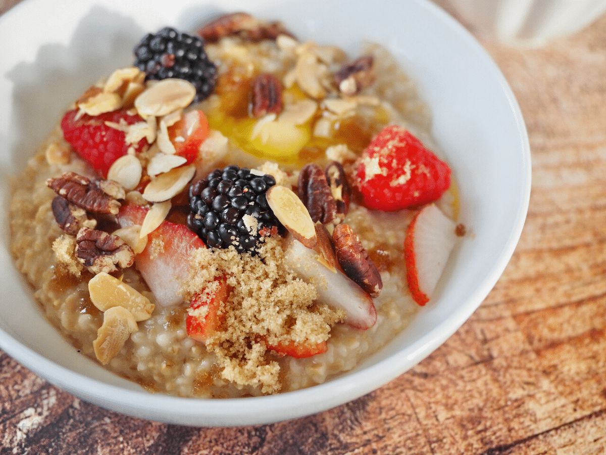 Steel Cut Instant Pot Oatmeal in bowl with nuts and fruit toppings.