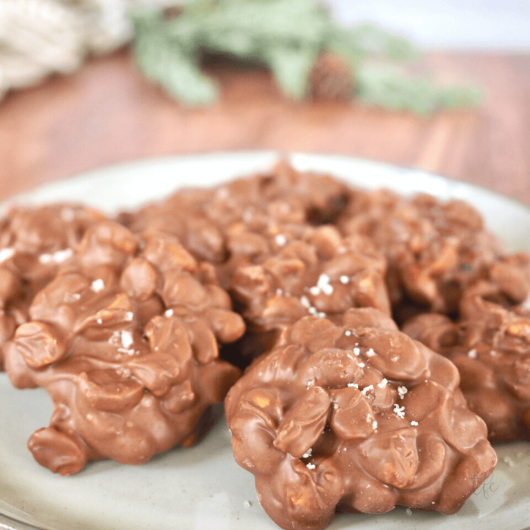 Plate of festive Crockpot peanut clusters.