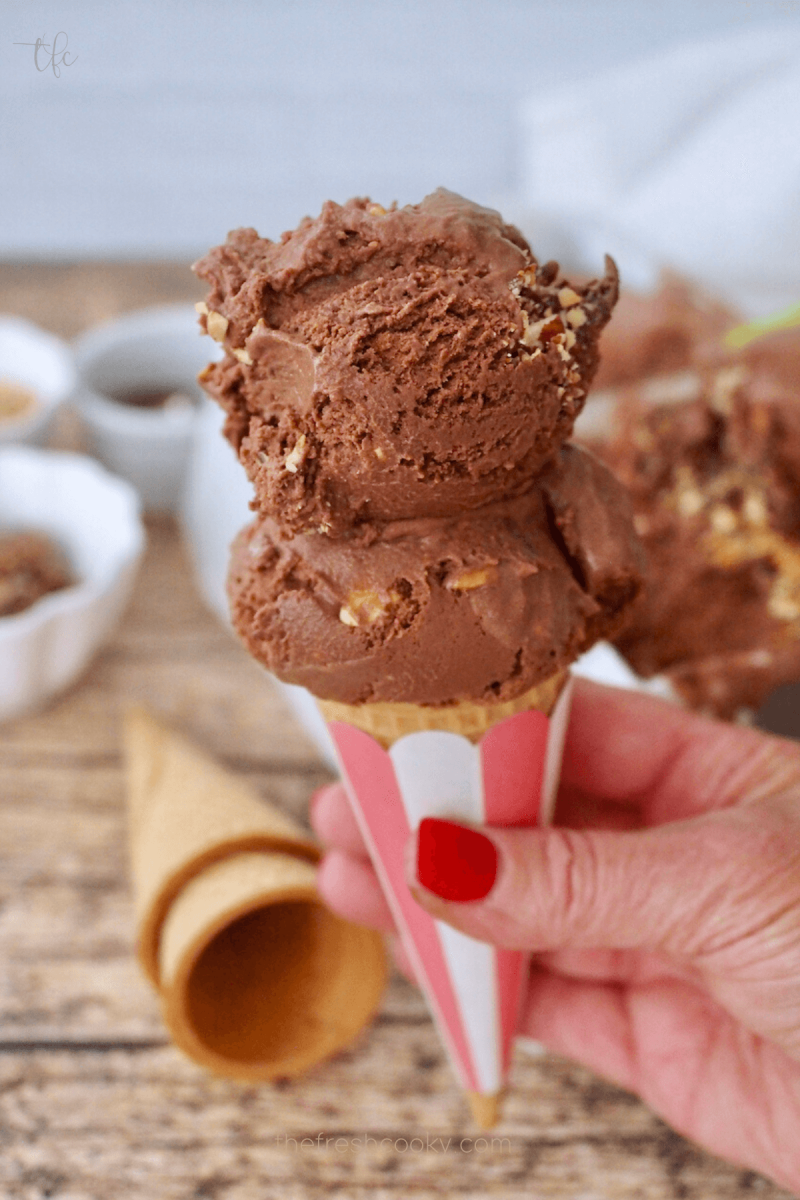 Two scoops of creamy Ferrero Rocher Gelato ice cream in cone. 