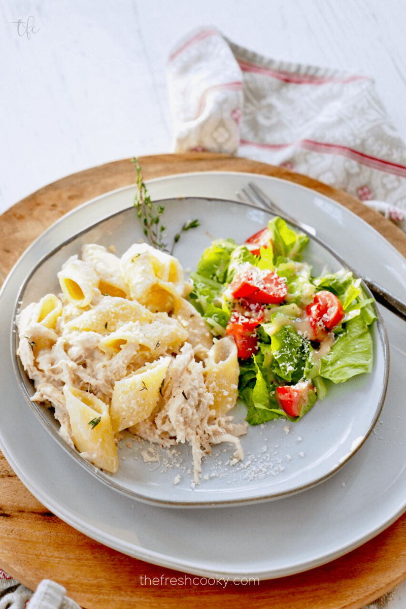 Olive Garden Crock Pot Chicken Pasta on plate with green salad.