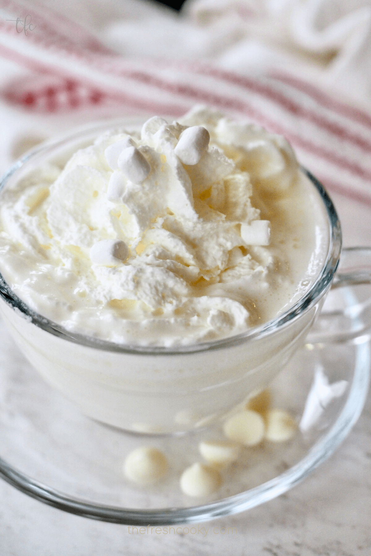Copycat Starbucks white hot chocolate with whipped cream and white chocolate chips and jimmies.