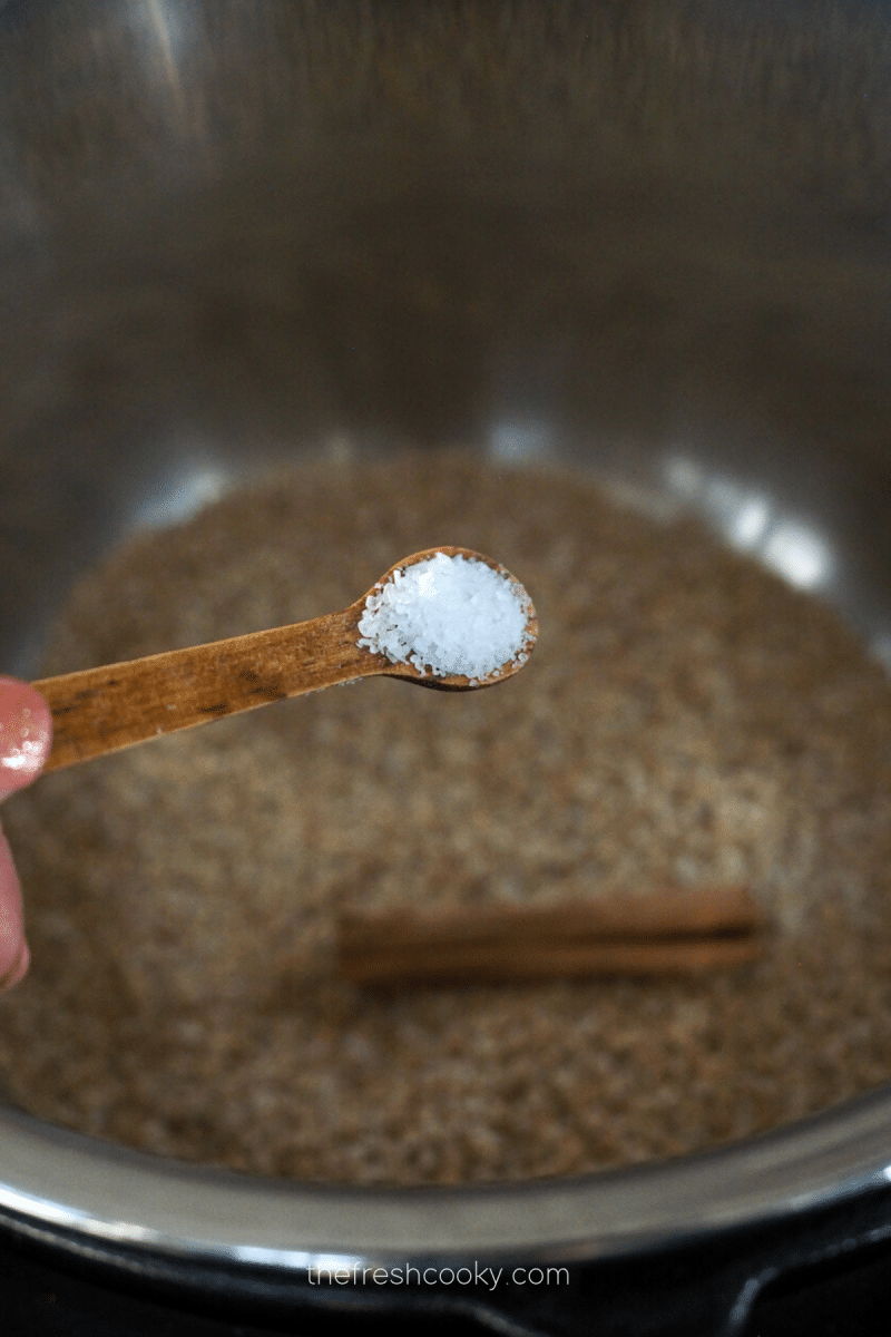 Add salt to pressure cooker oats. 