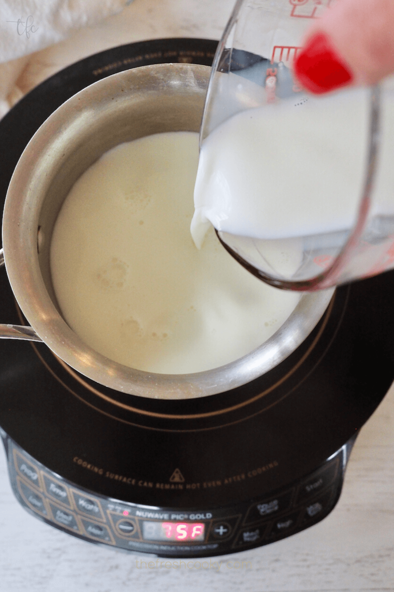 Pour milk into small saucepan for white hot chocolate.