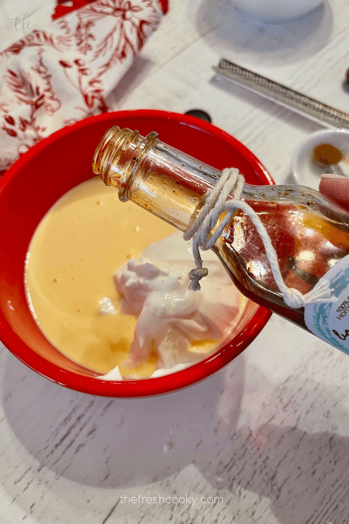 Adding vanilla to egg mixture. 