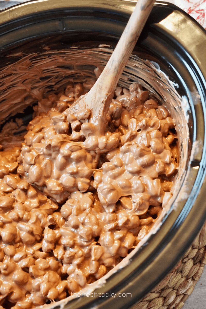 Final stir for crockpot peanut clusters, crock removed from crockpot. 