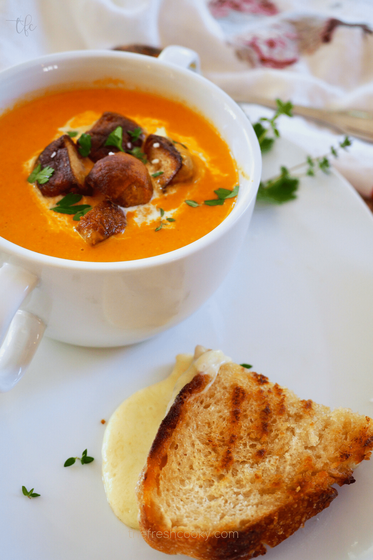 Serving suggestion grilled cheese with bowl of creamy tomato bisque soup recipe.