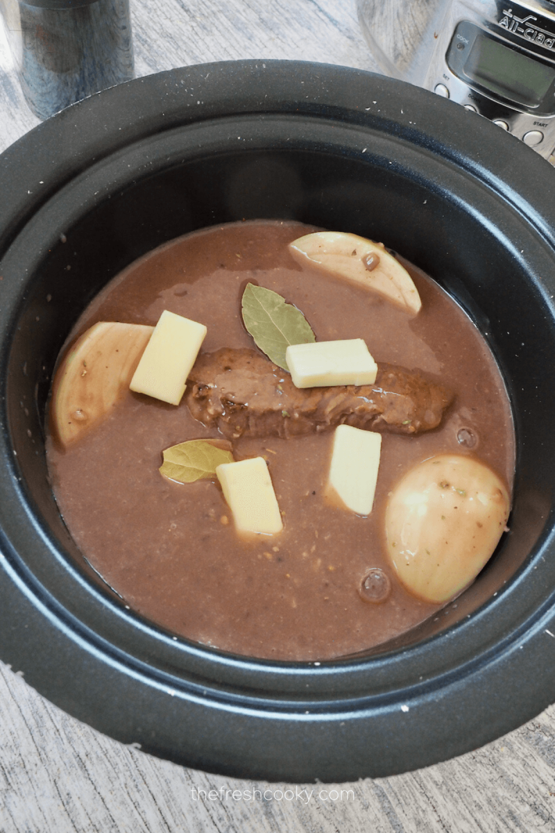 Added bay leaves, dotting the top with butter for crockpot London Broil. 