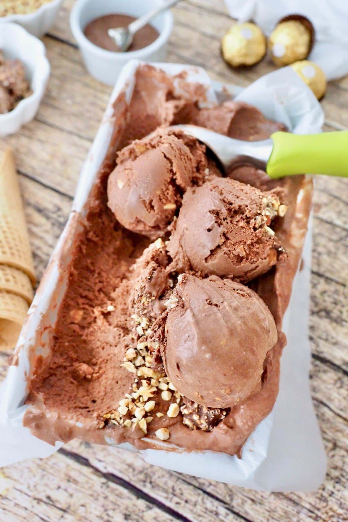 Ferrero ice cream in container with three scoops, scooped.