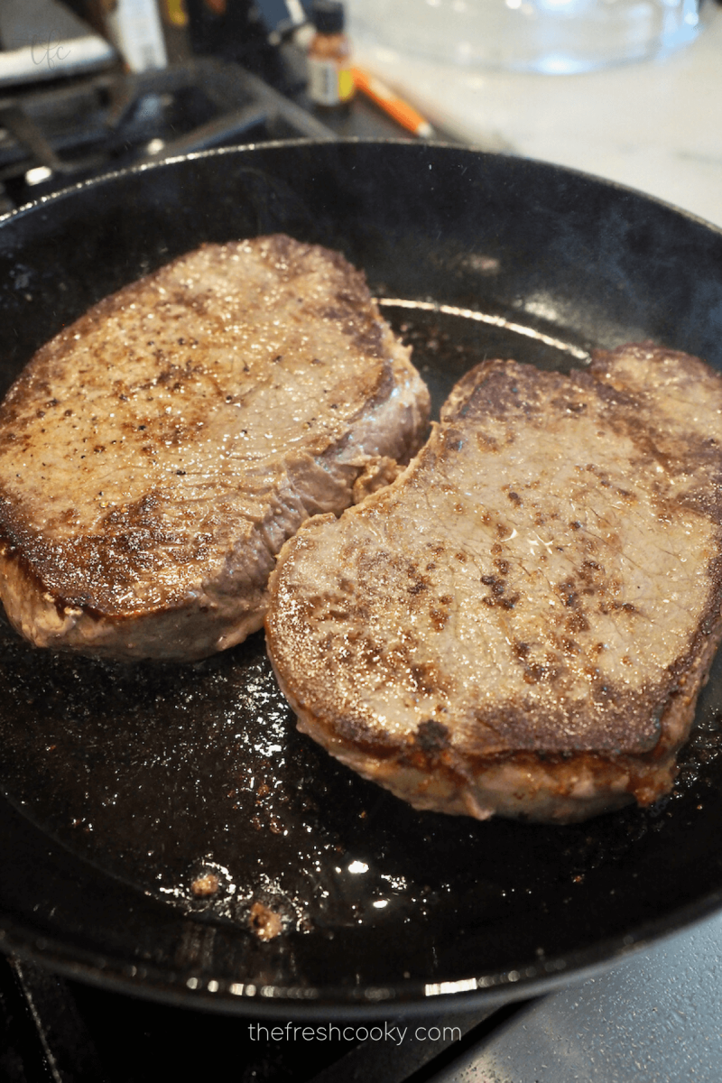 Searing London Broil in cast iron skillet. 