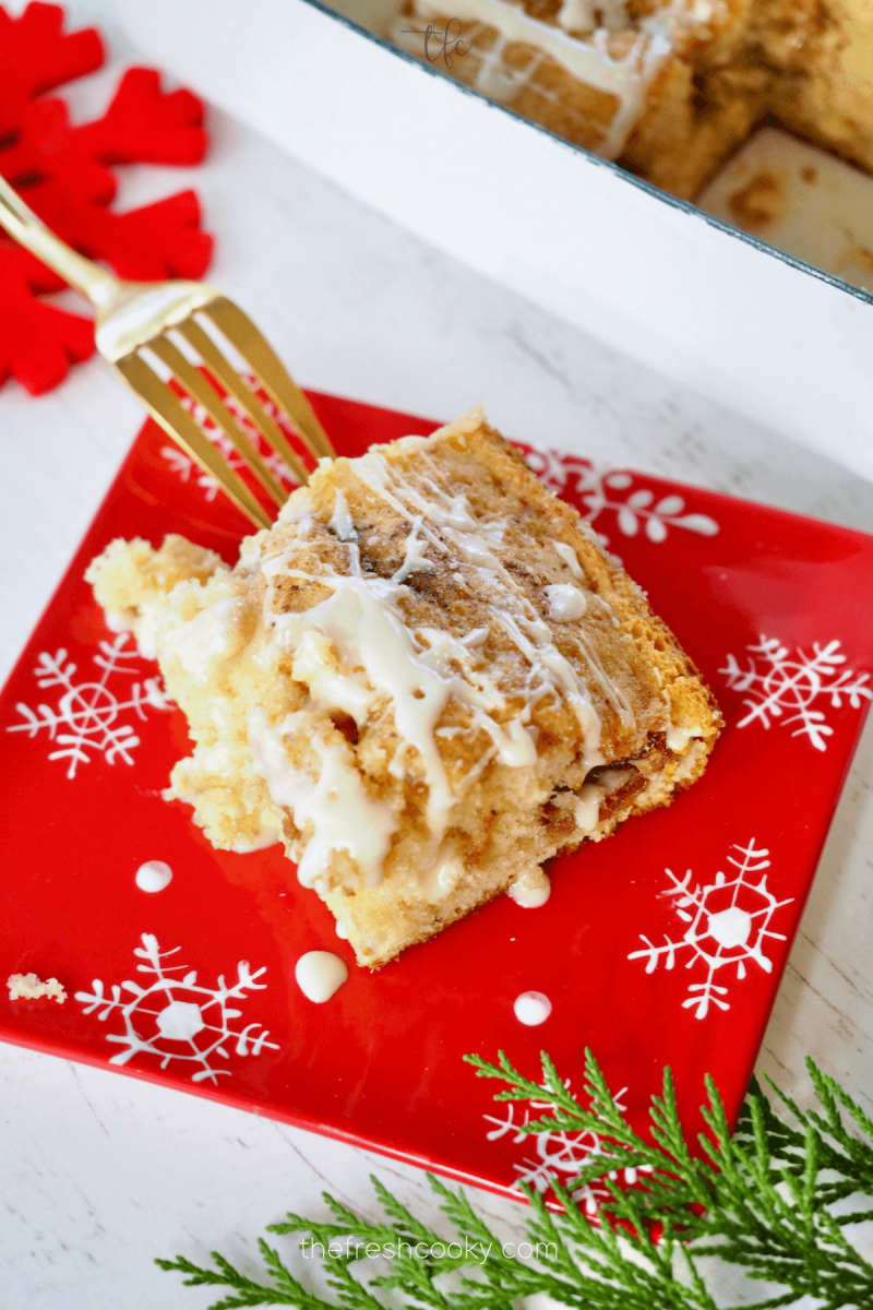 Slice of eggnog coffee cake top down shot with gold fork.