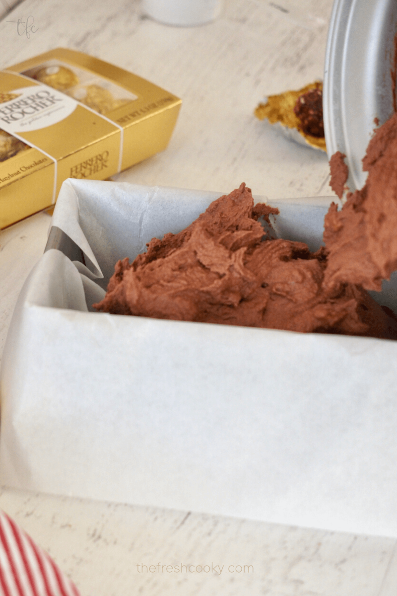 Scoop ice cream into parchment lined loaf pan or container for Ferrero Rocher Ice Cream. 