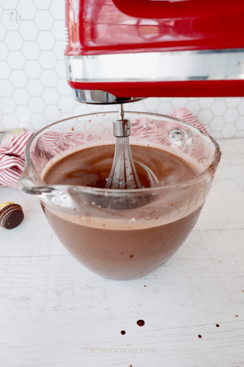 Using a hand mixer with whisk attachment to combine Ferrero Ice Cream batter. 