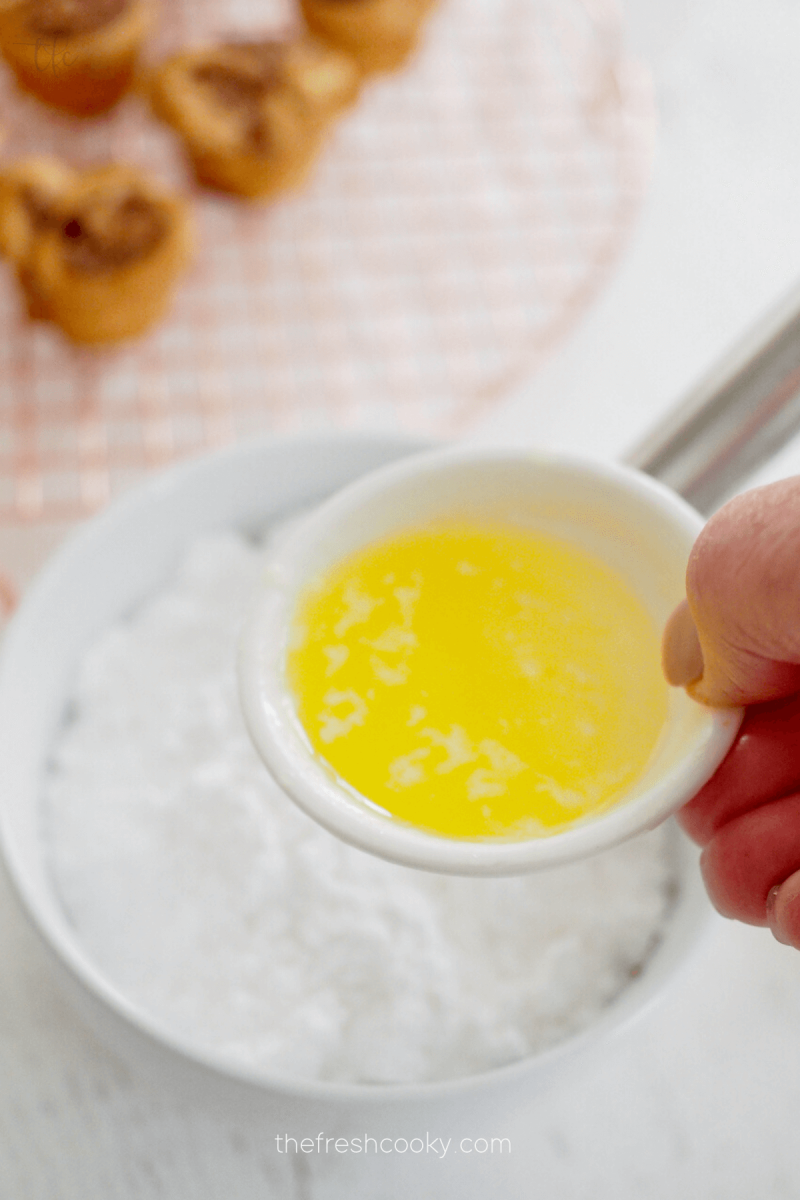 Adding optional melted butter for glaze for mini king cakes.