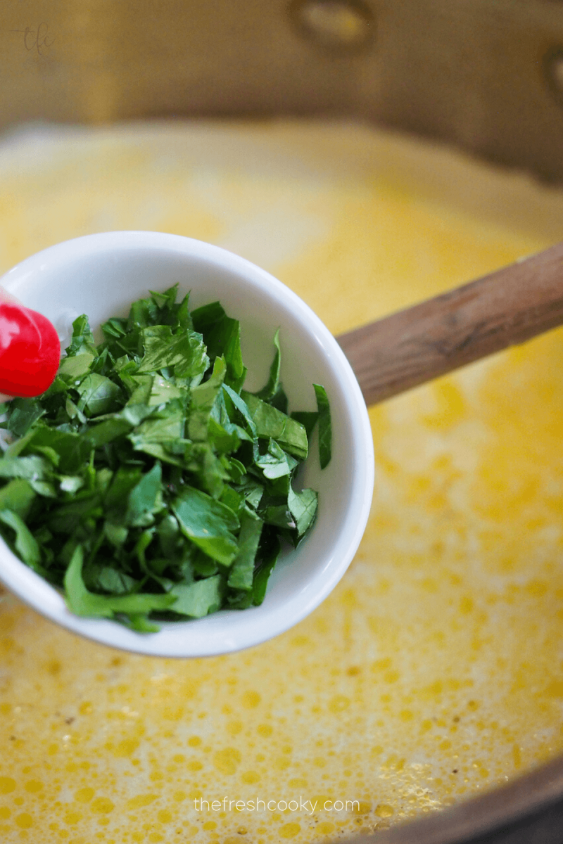Add fresh parsley to the alfredo sauce. 