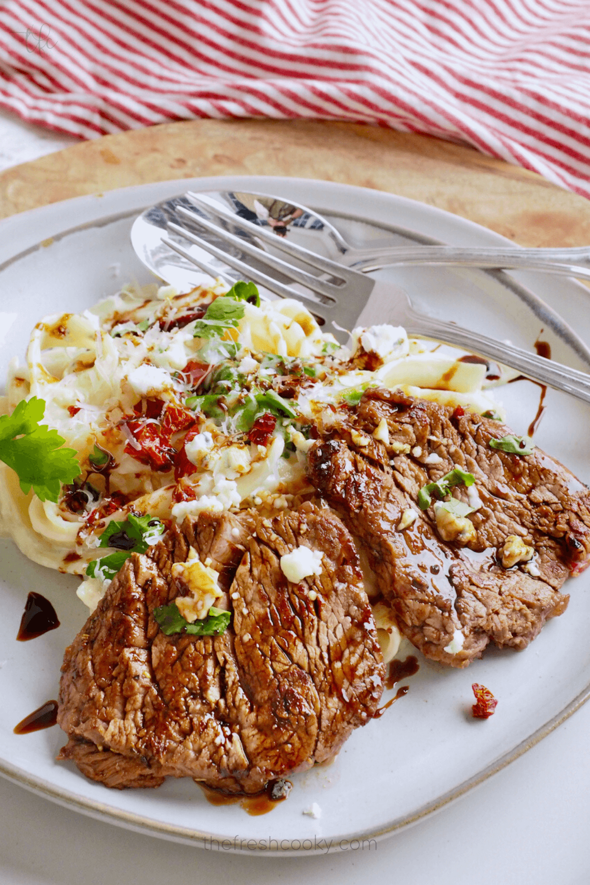 Olive Garden Steak Alfredo with Gorgonzola cheese on a bed of fettuccine alfredo.