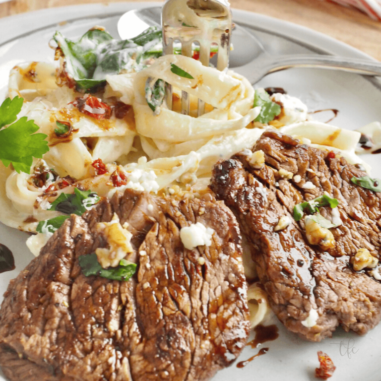 Olive Garden Steak Alfredo image with fork twirling fettuccine.