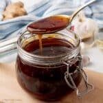 Spoonful of glossy and dark homemade teriyaki sauce.
