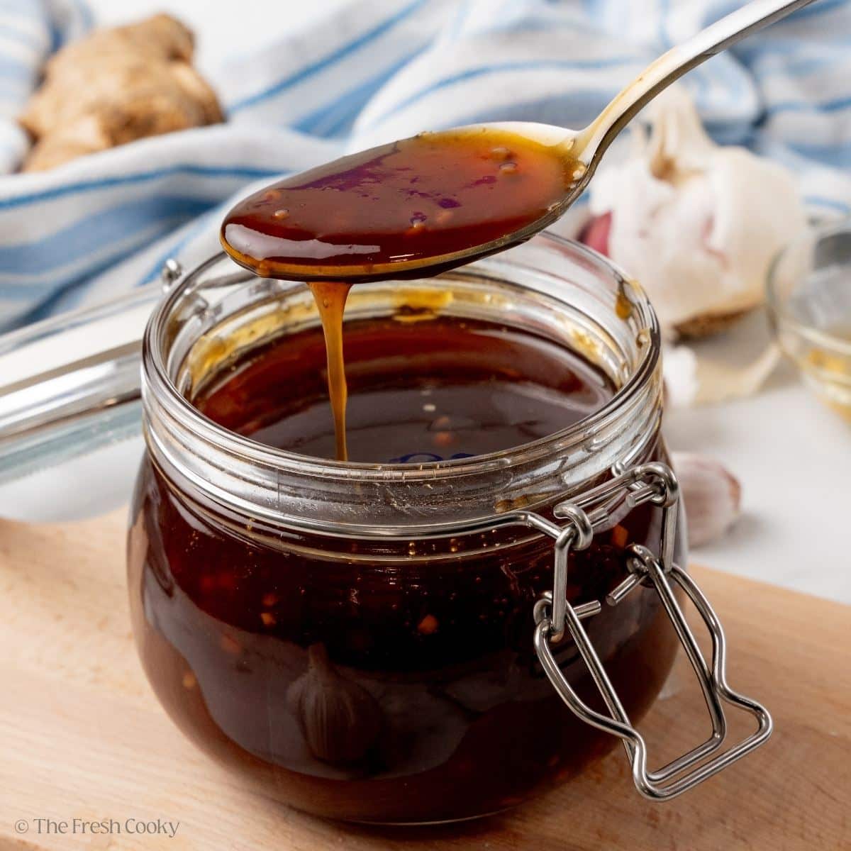 Spoonful of glossy and dark homemade teriyaki sauce.