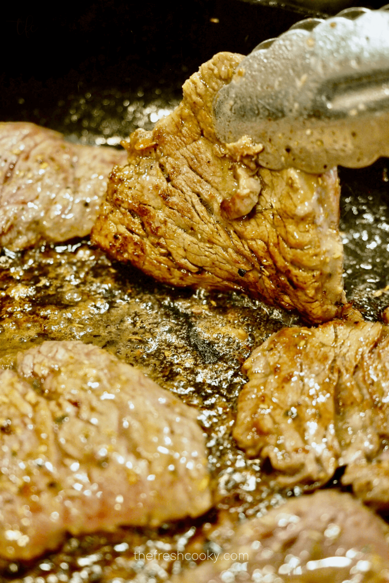 Cooking Olive Garden steaks in pan.