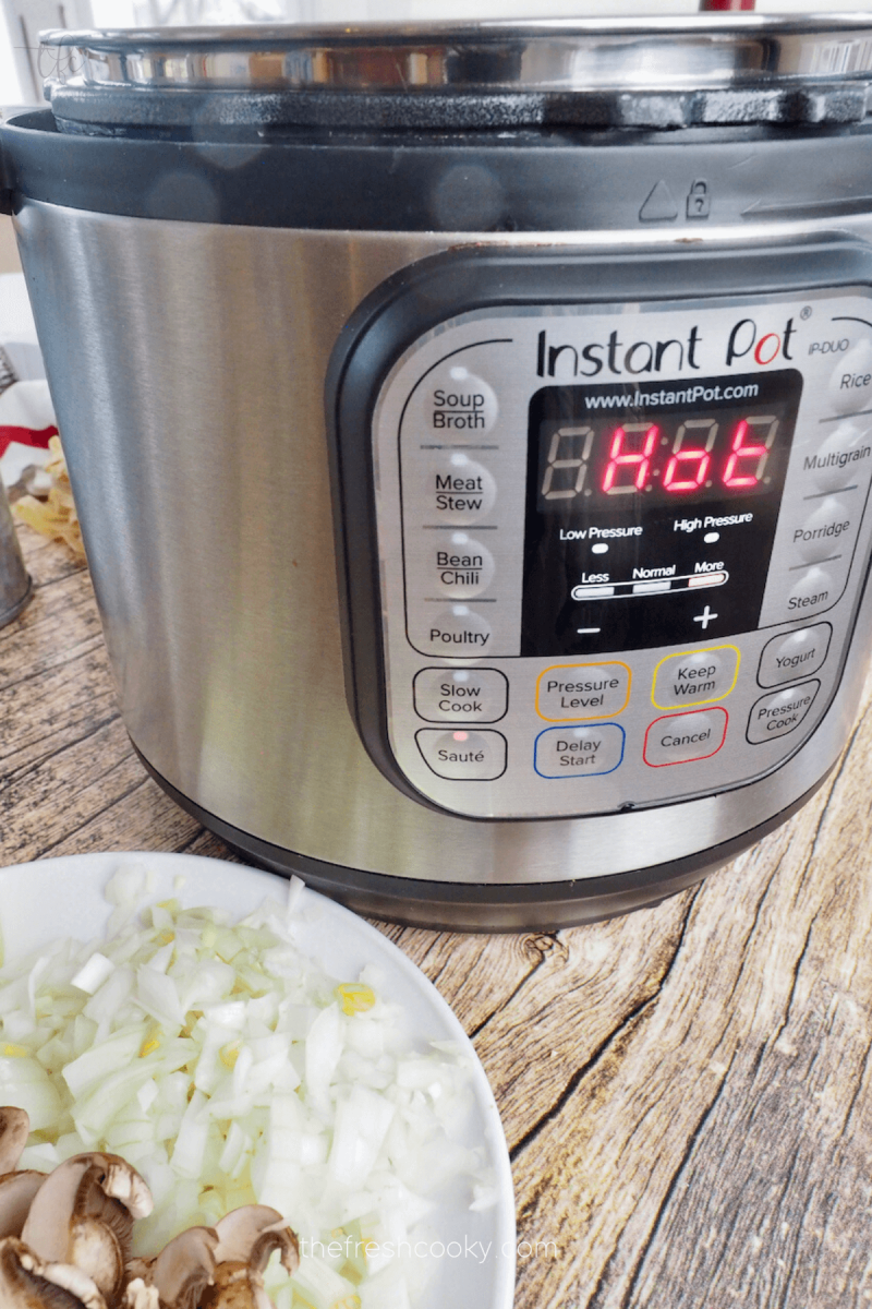 Instant Pot set to saute setting and display reads HOT for Instant Pot Ground Beef Stroganoff.