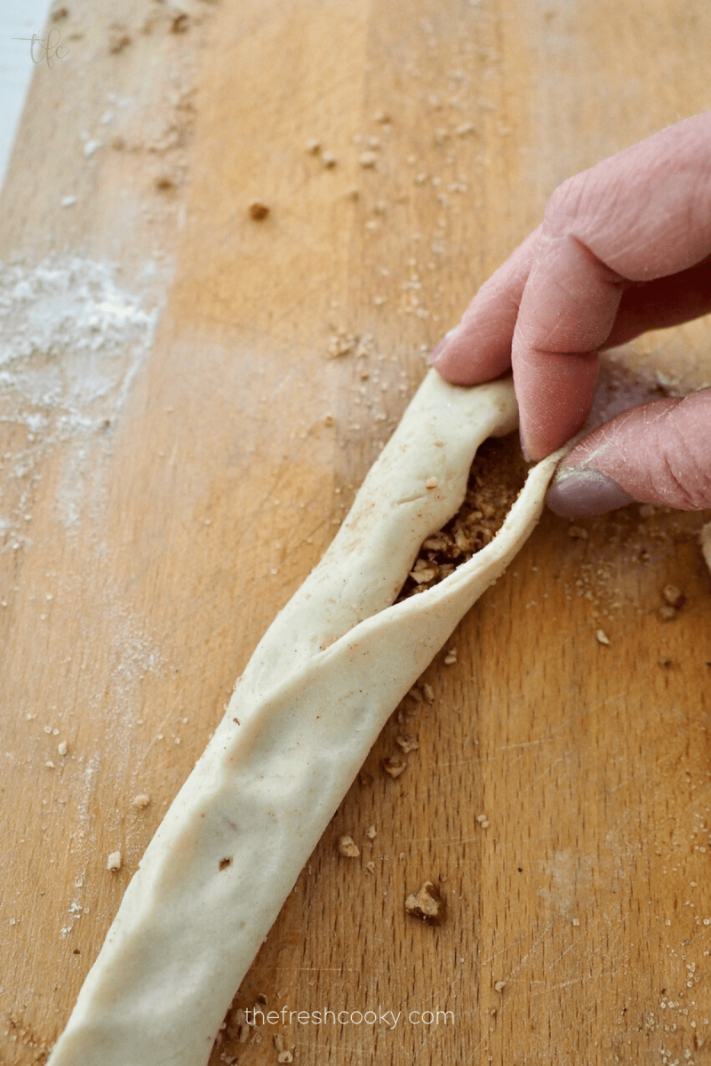 Pinch seams together to form cinnamon roll dough. 