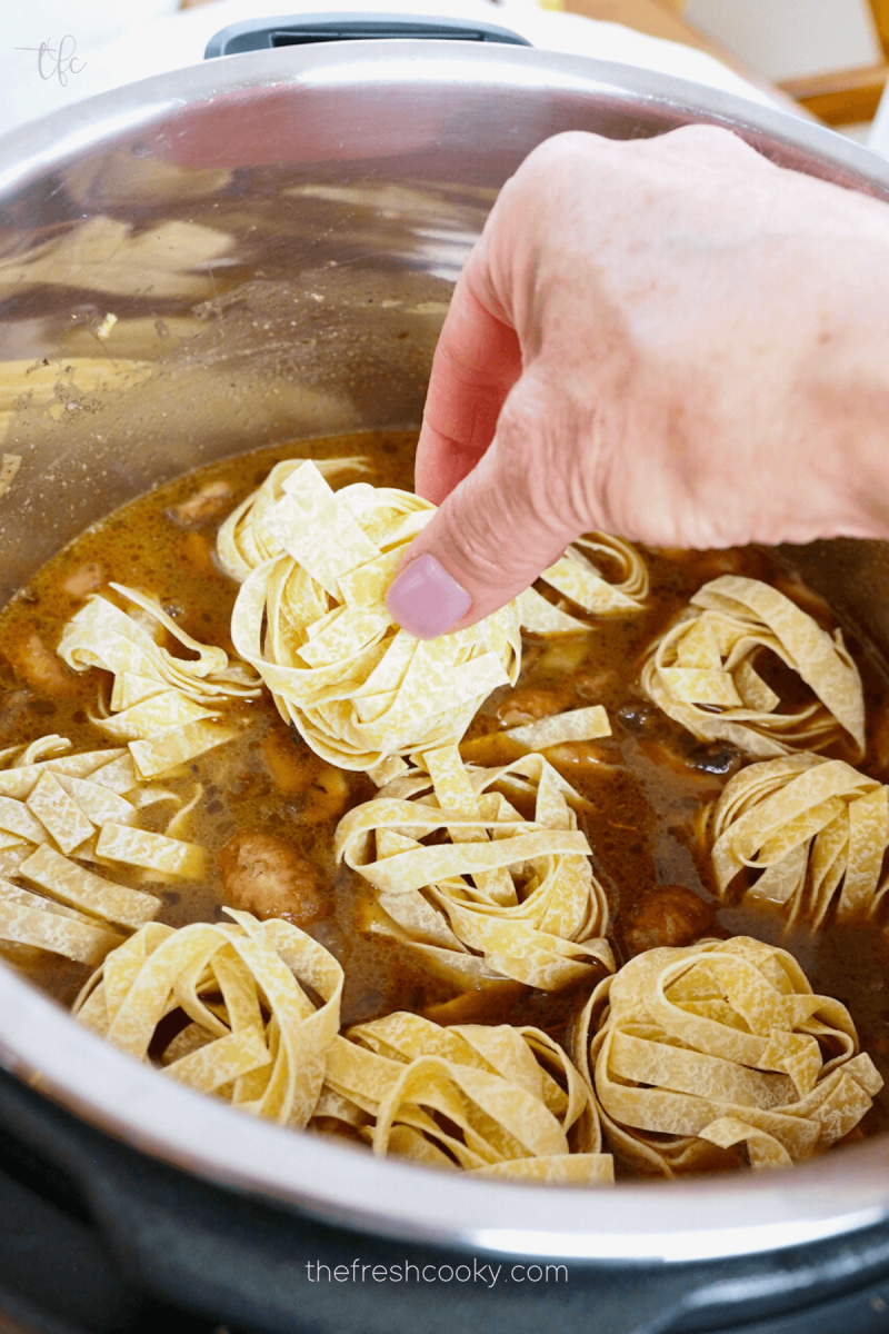 Add egg noodles to liquid in instant pot for Instant Pot Ground Beef Stroganoff.