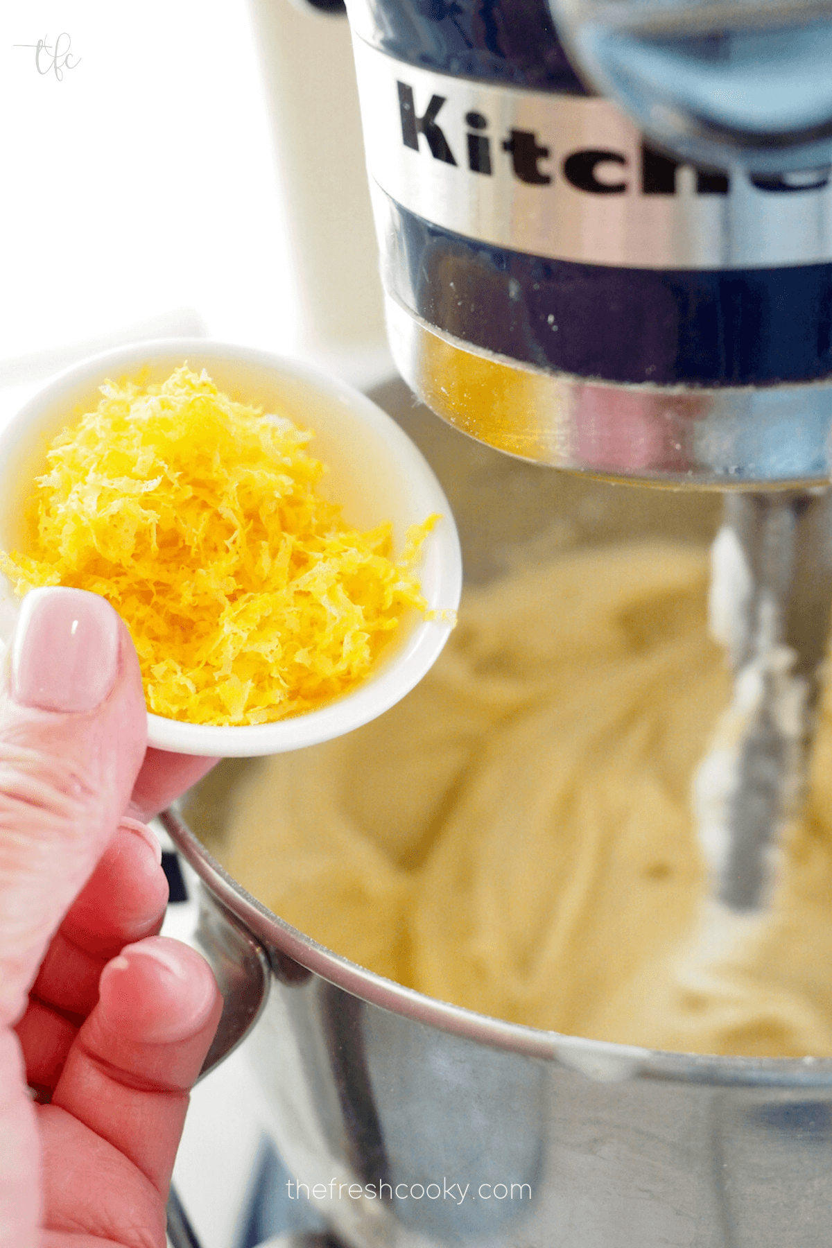 Adding lemon zest to cake batter. 